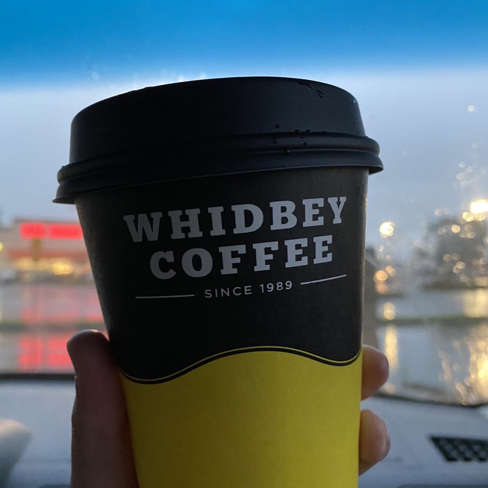 a hand holding a coffee cup