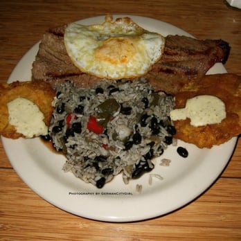 Mojito - Bistec a Caballo - marinated + grilled thin cut steak served with congrí, tostones + topped with a fried egg. - Cuban Near Me - Seattle, Washington