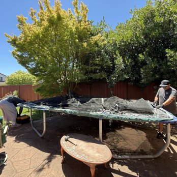 All Roses Junk Hauling - Before pic of trampoline in our backyard and crews dismantling it. - Junk Removal & Hauling Near Me - San Jose, California