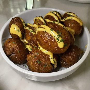 Abrielle - a bowl of baked potatoes with cheese sauce - Seafood Near Me - Toronto, Ontario Abrielle - a bowl of baked potatoes with cheese sauce - Seafood Near Me - Toronto, Ontario