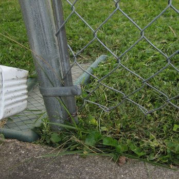 Solar Earth Lawn Care - a person's feet in the grass next to a fence - Lawn Services Near Me Solar Earth Lawn Care - a person's feet in the grass next to a fence - Lawn Services Near Me