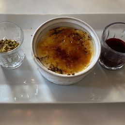 Malabi  Brûlée  with beet root reduction and honey sauce and toasted pistachios -- completely original and divine