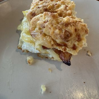 Cafe At Cold Holllow - "Breakfast Core" bacon, egg and cheese on a homemade cheddar biscuit- half eaten. - Breakfast & Brunch Near Me - Waterbury, Vermont