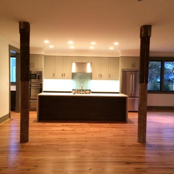 Concept 8 - a kitchen with hardwood floors and white cabinets - General Contractors Near Me - Apex, North Carolina