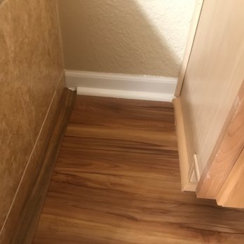 LL Flooring - Slidell - Quarter round on wall and cabinet( painted by customer) transition by tub surround - Flooring Near Me - Slidell, Louisiana