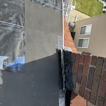 Rod's Construction - Step flashing for chimney + chimney cement - Roofing Near Me