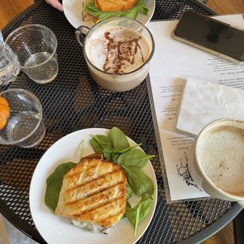 Cafe d'Marie - a person eating a sandwich and a cup of coffee - Coffee & Tea Near Me - Davenport, Iowa Cafe d'Marie - a person eating a sandwich and a cup of coffee - Coffee & Tea Near Me - Davenport, Iowa