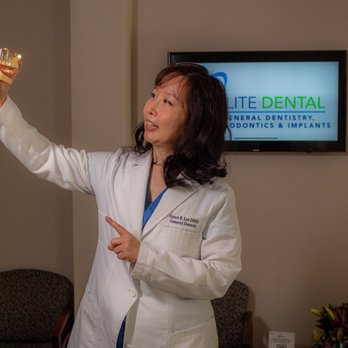 Elite Dental - Chicago dentist Dr. Grace Lee educating patient about dental implants using dental model at Elite Dental - General Dentistry Near Me - Chicago, Illinois