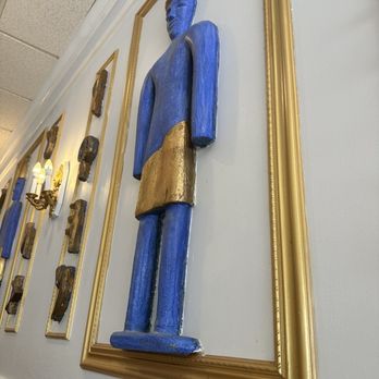 Phoenicia Gourmet - a blue statue in a gold frame - Mediterranean Near Me - Ocean Springs, Mississippi