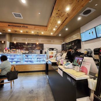 Tous Les Jours - Inside: dining area, pastry display case, and ordering counter. - Bakeries Near Me - Fullerton, California