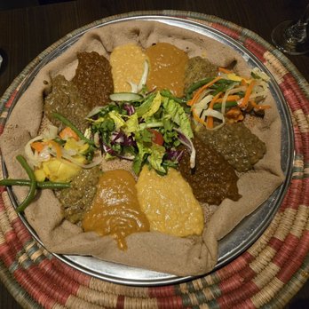 Zeret Kitchen - Their house favorite vegan selection atop a platter of injera - Ethiopian Near Me - London, XGL Zeret Kitchen - Their house favorite vegan selection atop a platter of injera - Ethiopian Near Me - London, XGL