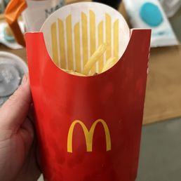 a hand holding a french fries