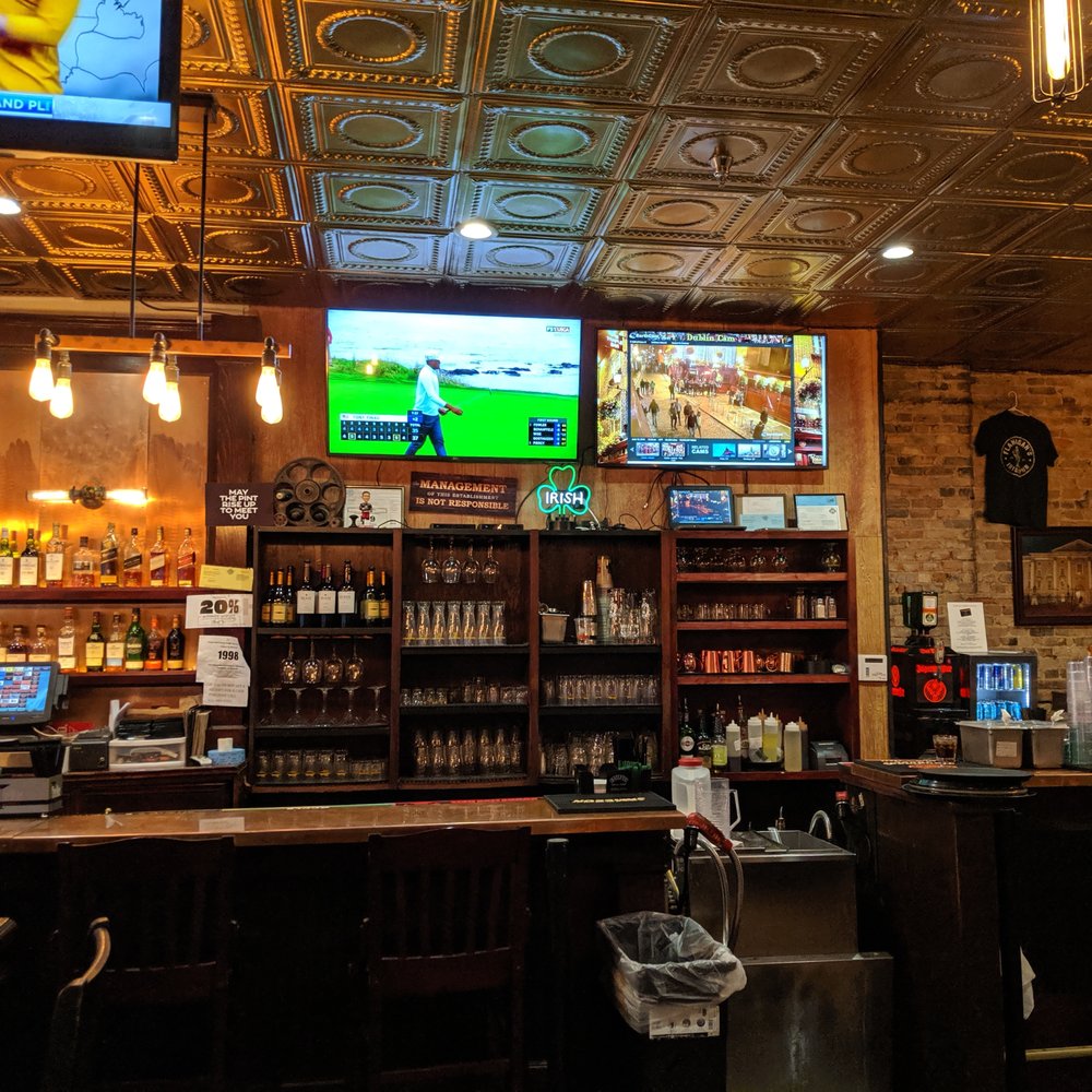 Flanagan's Irish Pub - The bar, with the Temple Bar stream on the right screen - Irish Near Me - Grand Rapids, Michigan