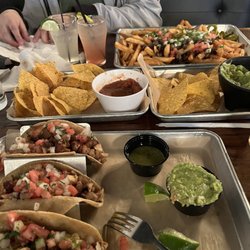 Baja Tacos and Shots - Pollo tacos and in back Carne Asada Fries Special (no cheese). So good! Loved the guac