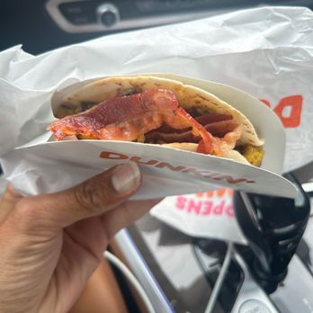 Dunkin' -  a person holding a hot dog in a wrapper - Donuts Near Me - South Brunswick, New Jersey