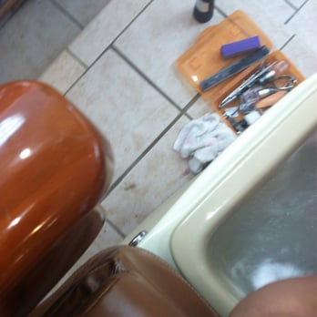 Wonder Nails - One side of the pedicure chair with the wet floor, soiled wet towels and unsterilized equipment. - Nail Salons Near Me - Washington, DC, District of Columbia