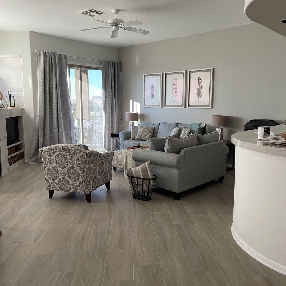 Pro Floors - a living room with a couch and chairs - Flooring Near Me Pro Floors - a living room with a couch and chairs - Flooring Near Me