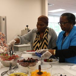 Greenhouse Ministries - Members of our Cooking Class making a delicious fruit salad!