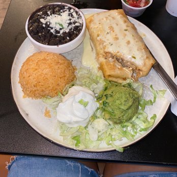 Pepe's Cantina - Shredded chicken chimichanga with black beans and Mexican rice. - Mexican Near Me - Clermont, Florida