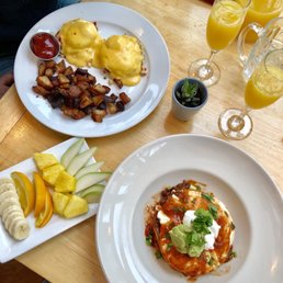 Crab eggs Benedict ($20) huevos rancheros ($13.50) seasonal fruit plate ($5) and a pitcher full of mimosas ($30)