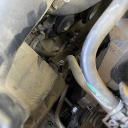 Jiffy Lube - Bolt on engine air filter cover that was left like this because it's difficult to get a screw driver in there.