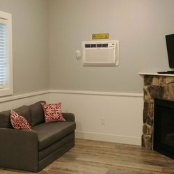 Lava Hot Springs West KOA Holiday - Living area with fireplace and TV