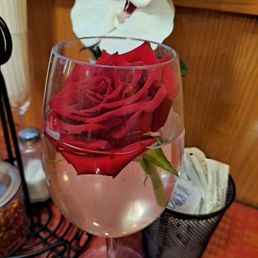 a rose in a wine glass a rose in a wine glass