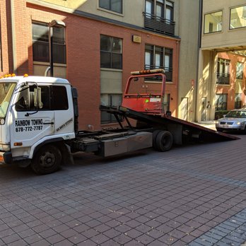 Rainbow Towing - Owner Hung Nguyen driving a car up onto his flatbed. - Towing Near Me Rainbow Towing - Owner Hung Nguyen driving a car up onto his flatbed. - Towing Near Me