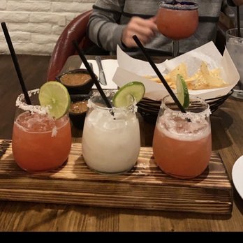 Los Sombreros - Large glass: strawberry margarita Margarita flight (left to right): Strawberry, Coconut and Watermelon - Mexican Near Me - Mesa, Arizona Los Sombreros - Large glass: strawberry margarita Margarita flight (left to right): Strawberry, Coconut and Watermelon - Mexican Near Me - Mesa, Arizona