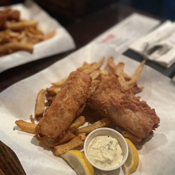 The Londoner - a plate of fish and chips with a side of lemon wedges - Pubs Near Me - Addison, Texas