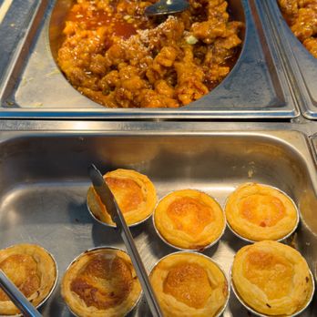 Kaijin Buffet - Front: Egg Tarts. Very little egg custard, but flaky, crisp shell. Tasty. Back: General Tso's Chicken - Buffets Near Me - New York, New York