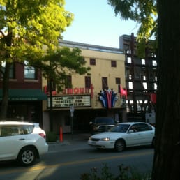 cars parked in front of a theater