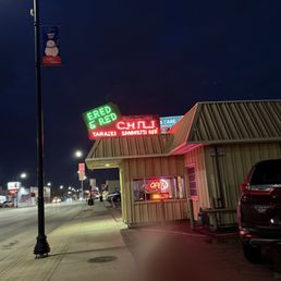 Front of building with old neon sign.