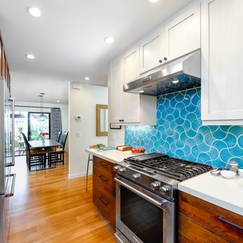 Ashton and Hope Construction - a kitchen with white cabinets and a blue tile backsplash - General Contractors Near Me - Santa Barbara, California Ashton and Hope Construction - a kitchen with white cabinets and a blue tile backsplash - General Contractors Near Me - Santa Barbara, California