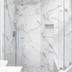 Reystone Construction - Ustom glass shower enclosure with porcelain tile and built-in niche.