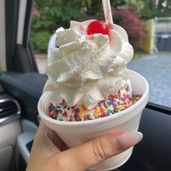 Lena's Water Ice & Custard - a hand holding a cup of ice cream with sprinkles and a cherry - Ice Cream & Frozen Yogurt Near Me - Lindenwold, New Jersey Lena's Water Ice & Custard - a hand holding a cup of ice cream with sprinkles and a cherry - Ice Cream & Frozen Yogurt Near Me - Lindenwold, New Jersey