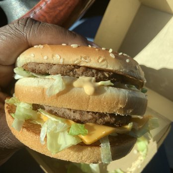 McDonald's - a hand holding a cheeseburger - Fast Food Near Me - Mint Hill, North Carolina McDonald's - a hand holding a cheeseburger - Fast Food Near Me - Mint Hill, North Carolina