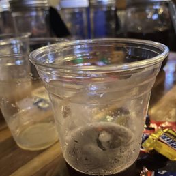 Cocktail in a plastic glass with mixers behind. Cocktail in a plastic glass with mixers behind.