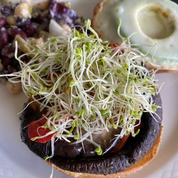 Garden Bistro - a mushroom sandwich with sprouts on a white plate - New American Near Me - Lakeland, Florida