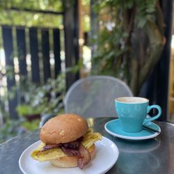 Red Arrow Coffee - Egg Sandwich: scrambled eggs, bacon, chive, aged cheddar, chili aioli, brioche bun