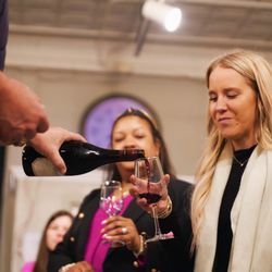 Unwind on Central - Pouring a glass of wine to celebrate a great meeting