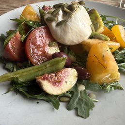 heirloom tomato and fresh fig, sweet pea salad with burrata, pumpkin seed and sesame seeds heirloom tomato and fresh fig, sweet pea salad with burrata, pumpkin seed and sesame seeds