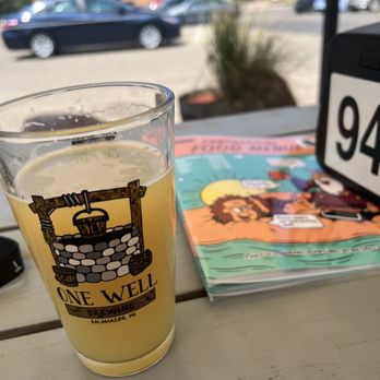 One Well Brewing - a pint of beer on a table - Breweries Near Me - Kalamazoo, Michigan One Well Brewing - a pint of beer on a table - Breweries Near Me - Kalamazoo, Michigan