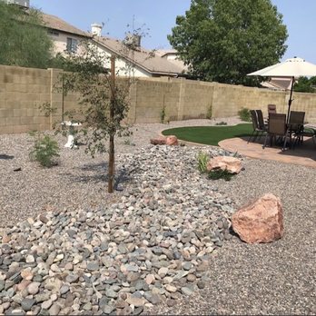 Versatile Establishment - a backyard with a gravel bed and patio furniture - Landscaping Near Me Versatile Establishment - a backyard with a gravel bed and patio furniture - Landscaping Near Me