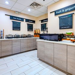 Holiday Inn Brownsville - Breakfast area with hot items, cereal, bakery, fruit, and yogurt in Brownsville.