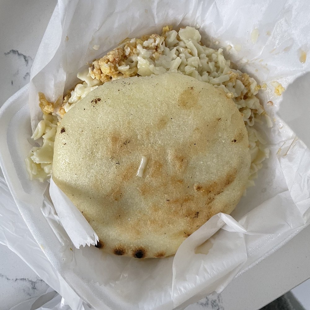 a close up of a flat bread in a paper wrapper