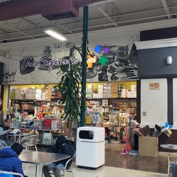 The Square Plus - Sitting in the food court across from The Square Plus - Food court with tables and chairs in front of The Square Plus store in Rosemead, CA, with customers seated and browsing. - Discount Store Near Me - Rosemead, California