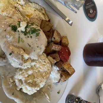 Sunset Grill - Biscuit and gravy AFTER I cut biscuit in half. - American Near Me - Fredericksburg, Texas Sunset Grill - Biscuit and gravy AFTER I cut biscuit in half. - American Near Me - Fredericksburg, Texas