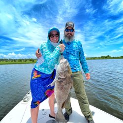 Captain Travis Blucher Charters - Zach and Michelle with a big black drum.