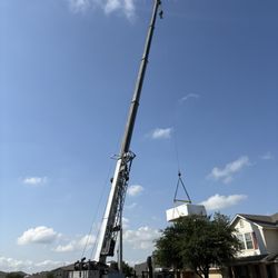 Sparta Crane and Drilling - Swim spa being flown from delivery flatbed to backyard.